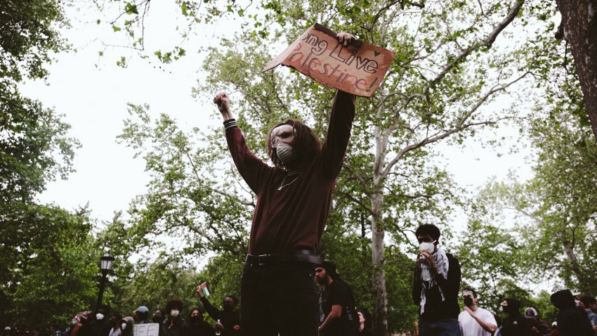 A protester holds up a signed that reads “Long Live Palestine” on campus after police declared an unlawful gathering on the grounds of the University of Virginia on May 4, 2024 in Charlottesville. Pro-Palestinian encampments have sprung up at college campuses around the country, with some demonstrators calling for schools to divest from Israeli interests amid the ongoing war in Gaza.